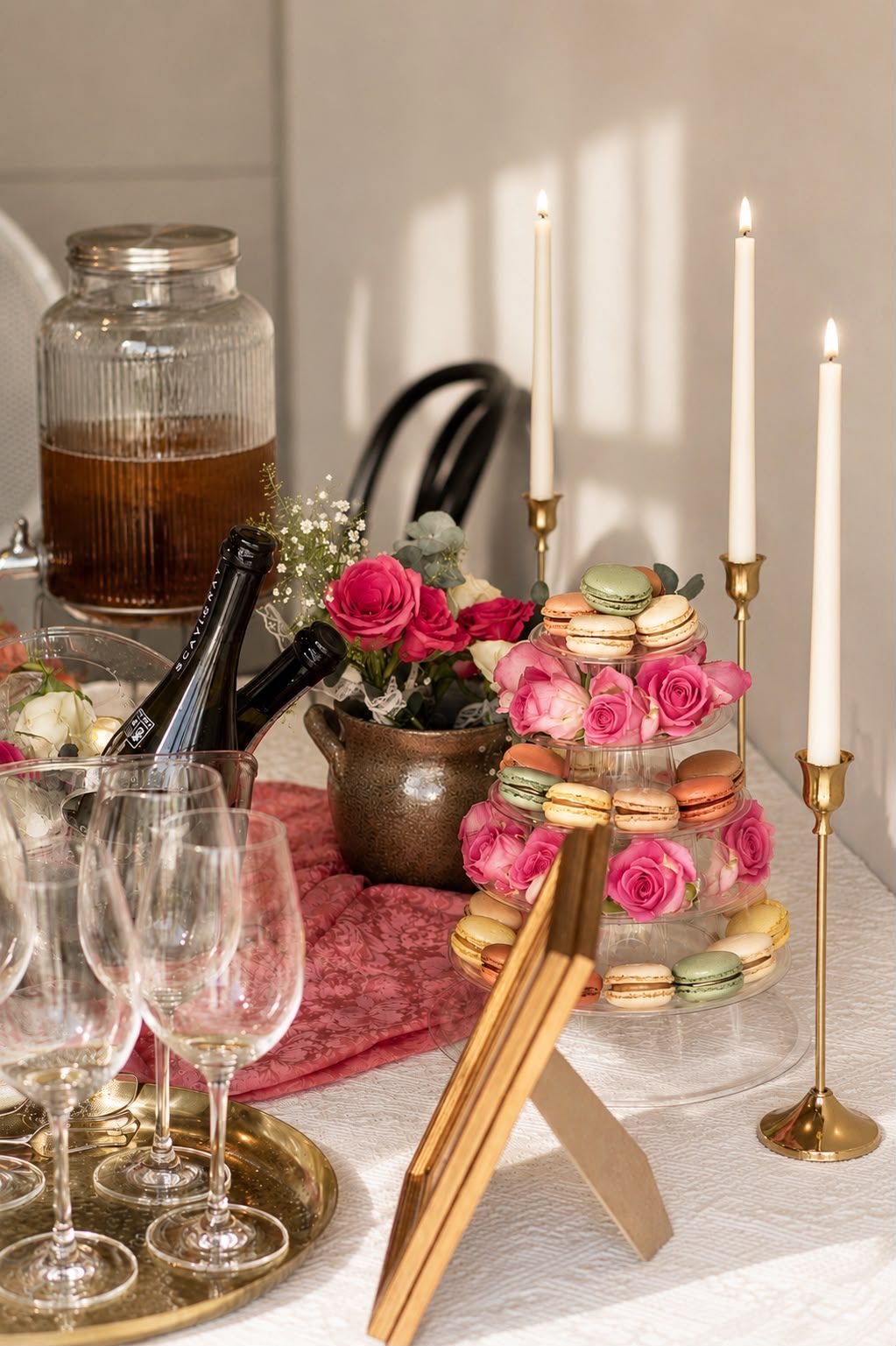 The Prosecco Parlour tablescape with macarons, roses, and candlelight, from a past Three Petals event